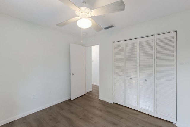 8985 Pohoy Ave, Sarasota, FL 34231 - unfurnished bedroom featuring wood finished floors, a closet, and a ceiling fan