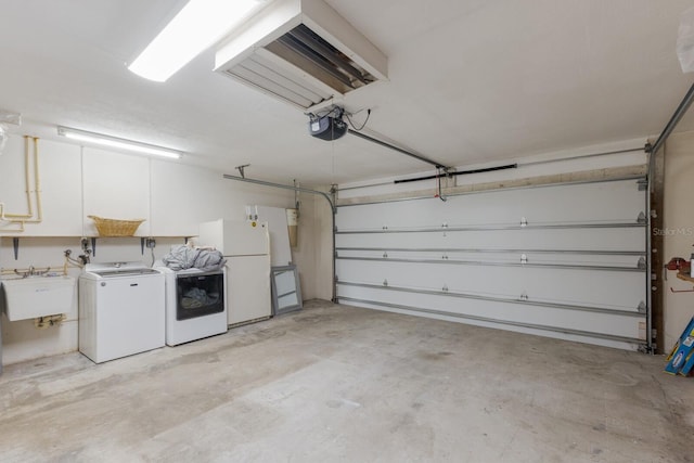 8985 Pohoy Ave, Sarasota, FL 34231 - garage with freestanding refrigerator, washing machine and dryer, and a garage door opener