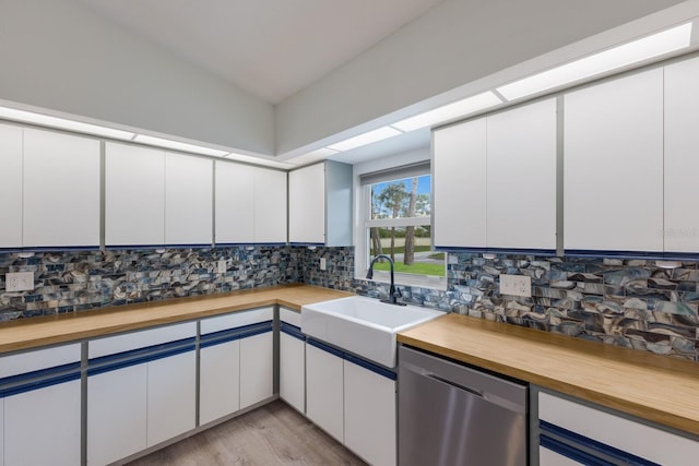 8985 Pohoy Ave, Sarasota, FL 34231 - kitchen with dishwasher, wood counters, backsplash, light wood-style floors, and lofted ceiling