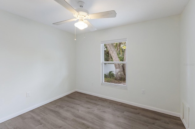 8985 Pohoy Ave, Sarasota, FL 34231 - spare room featuring wood finished floors and ceiling fan