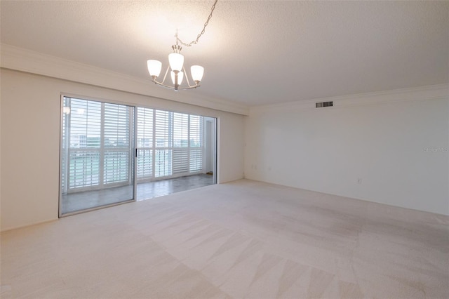 3680 Ironwood Cir Unit 603L, Bradenton, FL 34209 - empty room featuring a chandelier, carpet floors, ornamental molding, and a textured ceiling