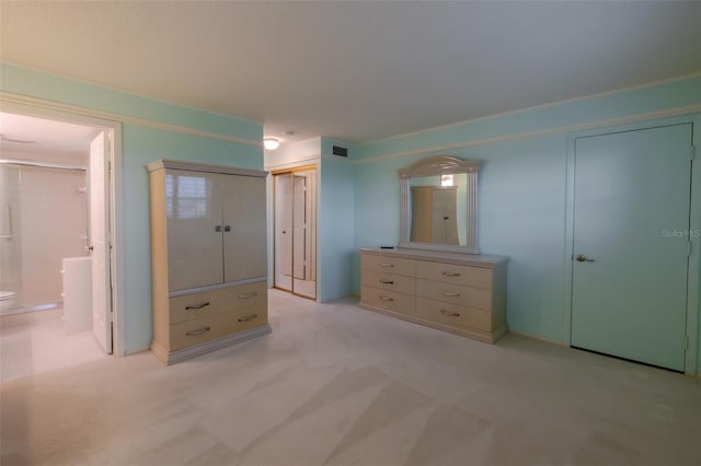 3680 Ironwood Cir Unit 603L, Bradenton, FL 34209 - unfurnished bedroom featuring light carpet, connected bathroom, and two closets