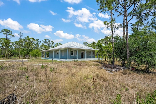 8146 Tropicaire Blvd, North Port, FL 34291 - view of front of property with covered porch and a metal roof