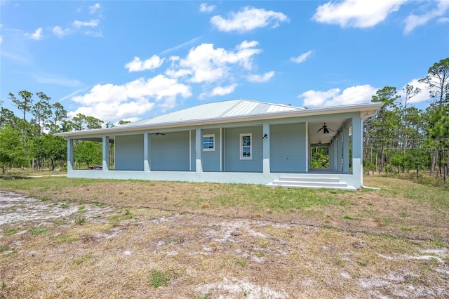 8146 Tropicaire Blvd, North Port, FL 34291 - view of front of house featuring ceiling fan, a metal roof, and covered porch
