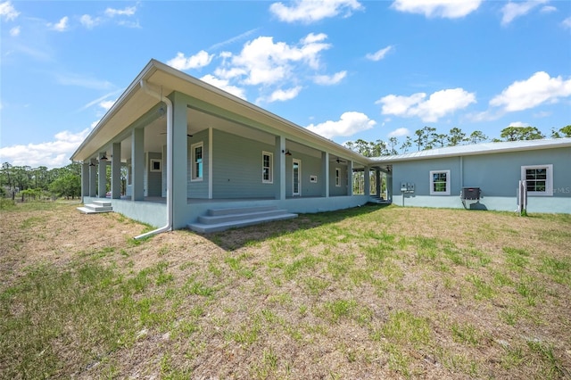 8146 Tropicaire Blvd, North Port, FL 34291 - back of house featuring a yard and covered porch