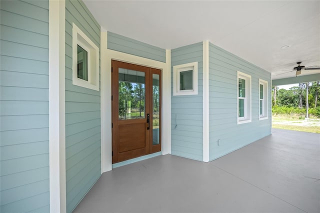 8146 Tropicaire Blvd, North Port, FL 34291 - doorway to property featuring covered porch and a ceiling fan