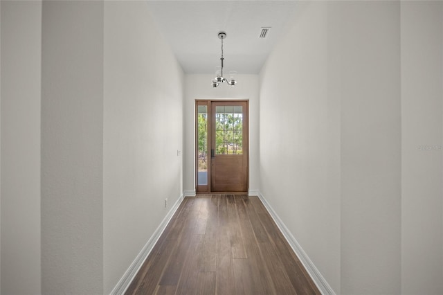 8146 Tropicaire Blvd, North Port, FL 34291 - entryway featuring dark wood finished floors and a chandelier
