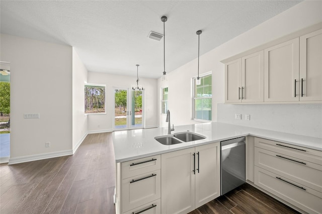8146 Tropicaire Blvd, North Port, FL 34291 - kitchen with dishwasher, a peninsula, dark wood-style floors, and light countertops