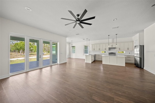 8146 Tropicaire Blvd, North Port, FL 34291 - unfurnished living room featuring a ceiling fan, dark wood-style floors, and recessed lighting