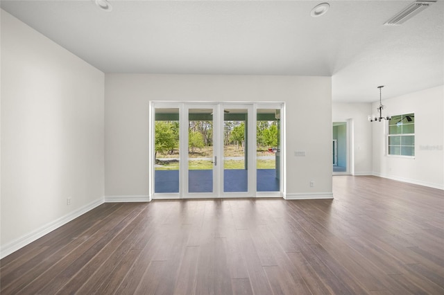 8146 Tropicaire Blvd, North Port, FL 34291 - spare room featuring dark wood-style floors and a chandelier