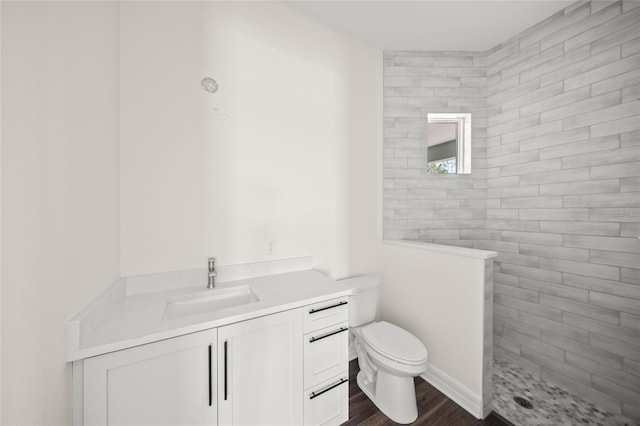 8146 Tropicaire Blvd, North Port, FL 34291 - bathroom with vanity, wood finished floors, and a tile shower