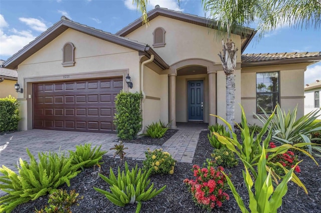 11221 Sandhill Preserve Dr, Sarasota, FL 34238 - mediterranean / spanish house with stucco siding, a garage, and decorative driveway