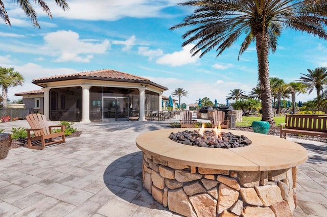 11221 Sandhill Preserve Dr, Sarasota, FL 34238 - view of patio featuring a sunroom and an outdoor fire pit