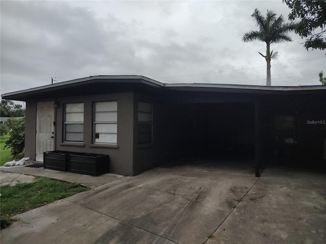 1423 17th Ave E, Bradenton, FL 34208 - view of property exterior with an attached carport and driveway