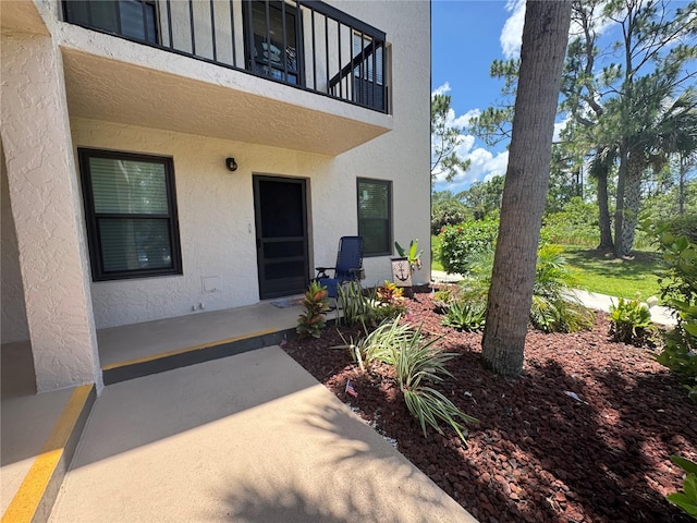 1999 Kings Hwy Unit 26A, Punta Gorda, FL 33980 - doorway to property featuring a balcony and stucco siding