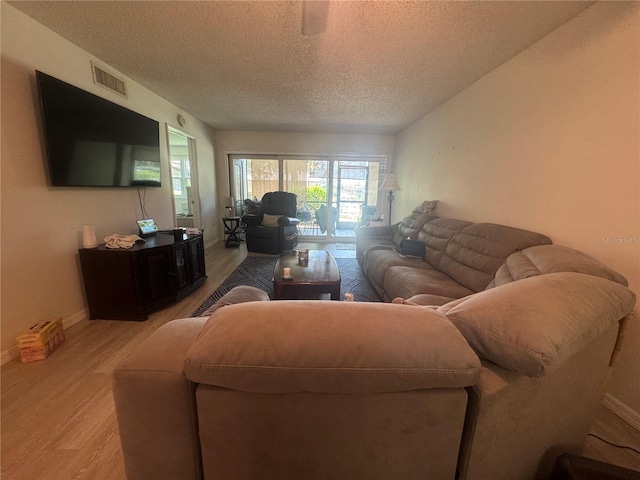 1999 Kings Hwy Unit 26A, Punta Gorda, FL 33980 - living room featuring light wood-type flooring and a textured ceiling