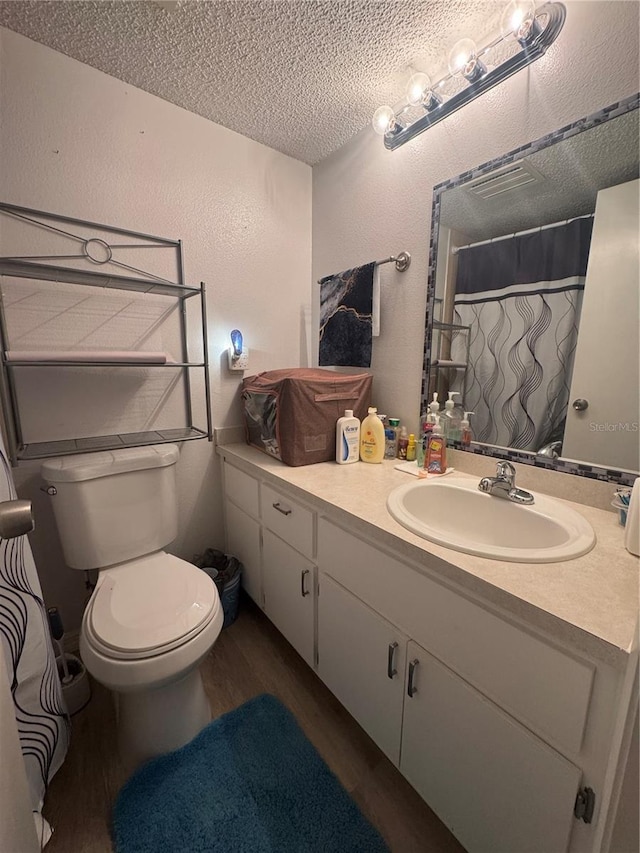 1999 Kings Hwy Unit 26A, Punta Gorda, FL 33980 - full bath with a textured wall, wood finished floors, vanity, a textured ceiling, and curtained shower