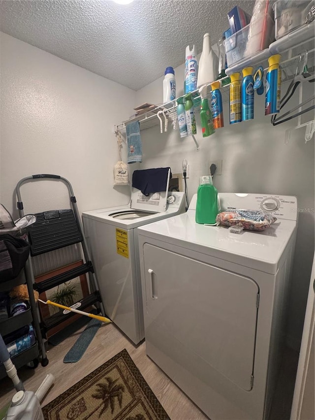1999 Kings Hwy Unit 26A, Punta Gorda, FL 33980 - washroom with separate washer and dryer, a textured ceiling, and light wood-style floors