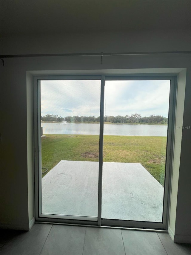 2824 Rock Sound St, Bradenton, FL 34208 - doorway to outside featuring a water view, healthy amount of natural light, and tile patterned flooring
