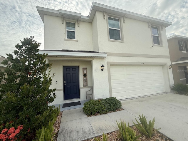 2824 Rock Sound St, Bradenton, FL 34208 - townhome / multi-family property featuring stucco siding, an attached garage, and concrete driveway