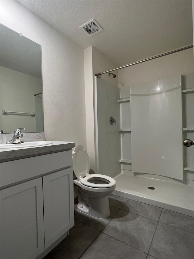 2824 Rock Sound St, Bradenton, FL 34208 - full bathroom with tile patterned flooring, a walk in shower, vanity, and a textured ceiling