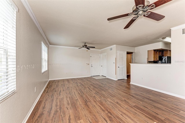 1030 Villagio Cir Unit 103, Sarasota, FL 34237 - unfurnished living room with a ceiling fan, wood finished floors, ornamental molding, and a textured wall