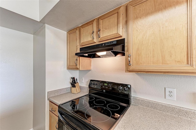 1030 Villagio Cir Unit 103, Sarasota, FL 34237 - kitchen featuring black range with electric stovetop, under cabinet range hood, and light countertops