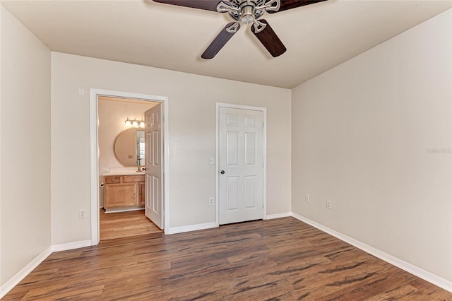 1030 Villagio Cir Unit 103, Sarasota, FL 34237 - unfurnished bedroom featuring wood finished floors, connected bathroom, and ceiling fan