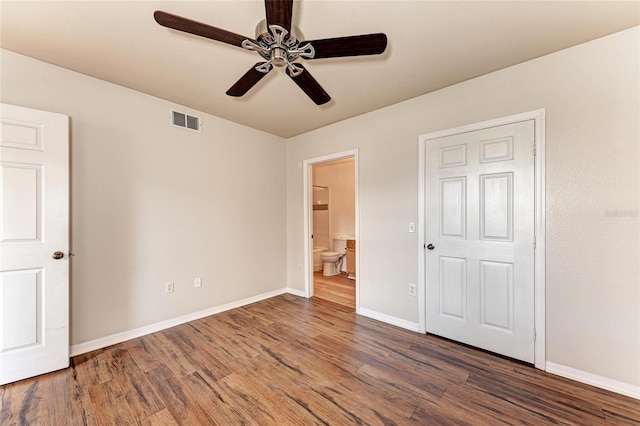 1030 Villagio Cir Unit 103, Sarasota, FL 34237 - unfurnished bedroom with wood finished floors, ensuite bathroom, and a ceiling fan