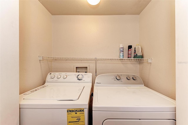 1030 Villagio Cir Unit 103, Sarasota, FL 34237 - washroom featuring washer and clothes dryer and a textured wall