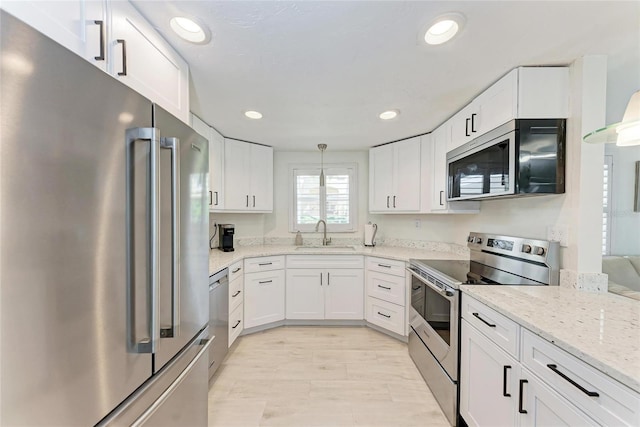 726 Jungle Queen Way, Longboat Key, FL 34228 - kitchen featuring stainless steel appliances, white cabinetry, light stone countertops, and recessed lighting