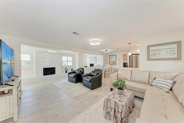 726 Jungle Queen Way, Longboat Key, FL 34228 - living area featuring light wood-style flooring and a high end fireplace