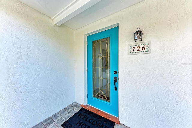 726 Jungle Queen Way, Longboat Key, FL 34228 - view of exterior entry with stucco siding