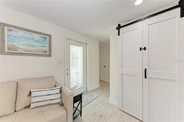 726 Jungle Queen Way, Longboat Key, FL 34228 - foyer featuring a barn door and light wood finished floors