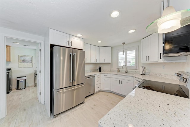 726 Jungle Queen Way, Longboat Key, FL 34228 - kitchen featuring appliances with stainless steel finishes, white cabinetry, recessed lighting, light wood-style flooring, and light stone counters