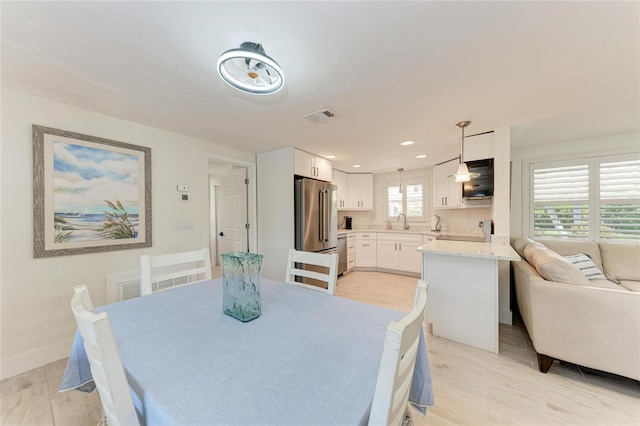726 Jungle Queen Way, Longboat Key, FL 34228 - dining area with light wood-style floors and recessed lighting