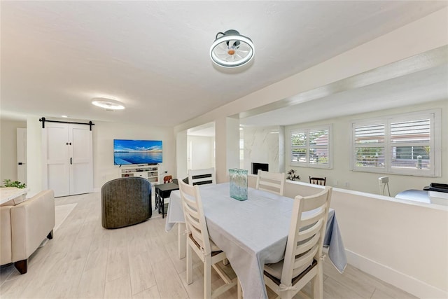726 Jungle Queen Way, Longboat Key, FL 34228 - dining space featuring a barn door and baseboards