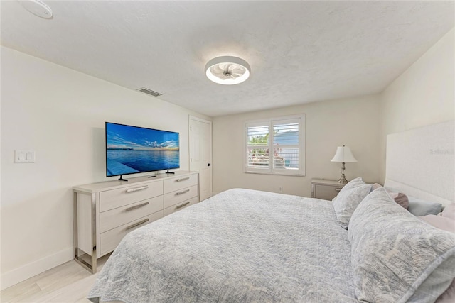 726 Jungle Queen Way, Longboat Key, FL 34228 - bedroom with light wood-style floors and baseboards