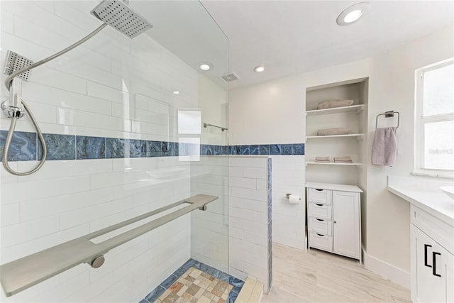 726 Jungle Queen Way, Longboat Key, FL 34228 - bathroom featuring a tile shower, vanity, recessed lighting, and built in shelves