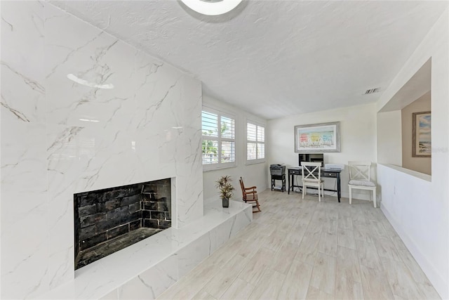 726 Jungle Queen Way, Longboat Key, FL 34228 - living room with a high end fireplace, wood finished floors, and a textured ceiling