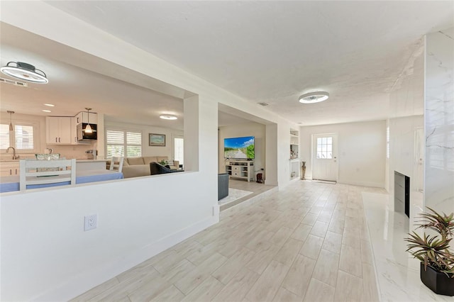 726 Jungle Queen Way, Longboat Key, FL 34228 - foyer entrance featuring a premium fireplace and light wood-type flooring