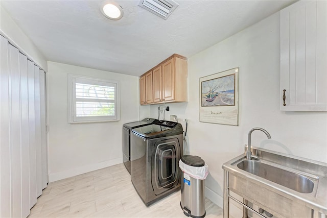 726 Jungle Queen Way, Longboat Key, FL 34228 - washroom featuring separate washer and dryer and cabinet space