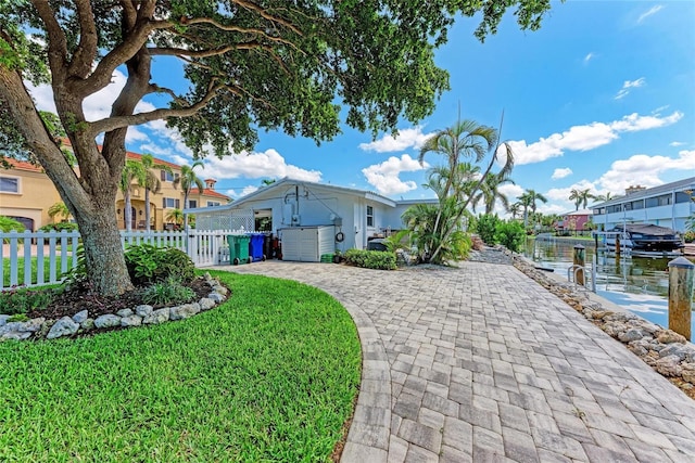 726 Jungle Queen Way, Longboat Key, FL 34228 - fenced yard featuring a boat dock, a water view, decorative driveway, and boat lift