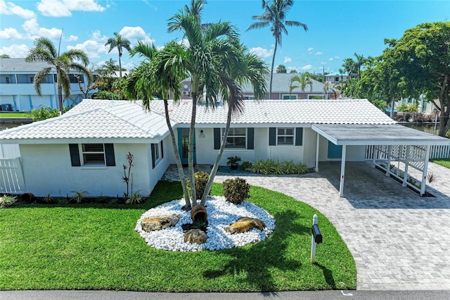 726 Jungle Queen Way, Longboat Key, FL 34228 - view of front facade with a front yard, driveway, stucco siding, and a tiled roof