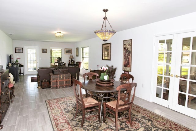 6504 Heritage Ln Unit 99, Bradenton, FL 34209 - dining space with french doors and wood finish floors