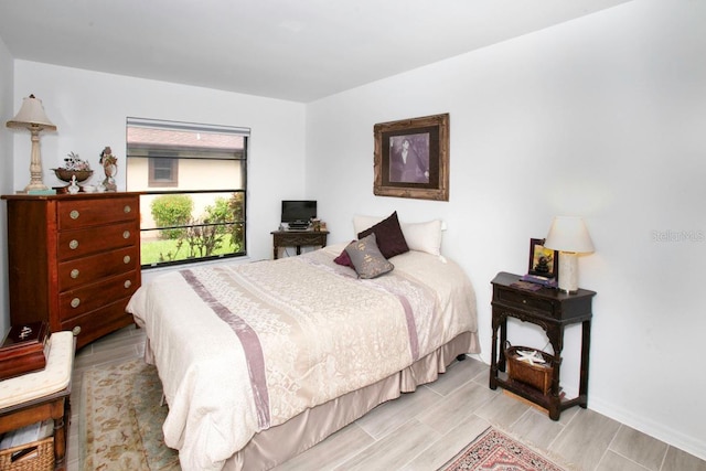 6504 Heritage Ln Unit 99, Bradenton, FL 34209 - bedroom with baseboards and light wood-style flooring