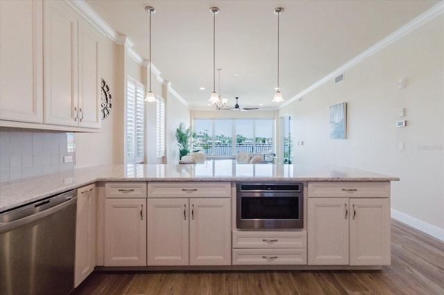 501 Tamiami Trl N Unit 201, Venice, FL 34285 - kitchen featuring appliances with stainless steel finishes, crown molding, a chandelier, a peninsula, and dark wood-style floors