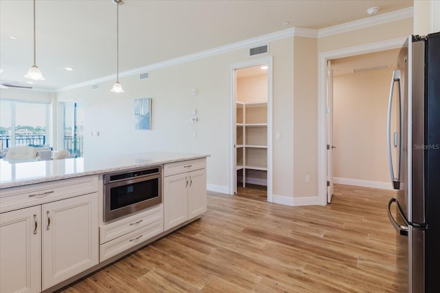 501 Tamiami Trl N Unit 201, Venice, FL 34285 - kitchen with appliances with stainless steel finishes, crown molding, white cabinets, light wood-type flooring, and hanging light fixtures