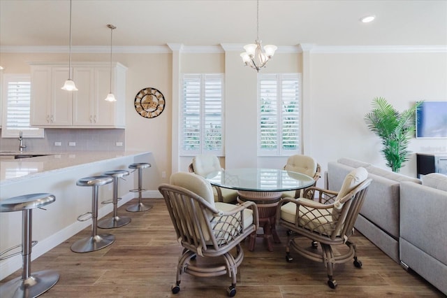 501 Tamiami Trl N Unit 201, Venice, FL 34285 - dining room featuring wood finished floors, a chandelier, ornamental molding, and recessed lighting