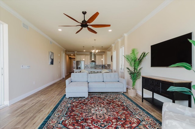 501 Tamiami Trl N Unit 201, Venice, FL 34285 - living area featuring ornamental molding, a ceiling fan, light wood-style floors, and recessed lighting